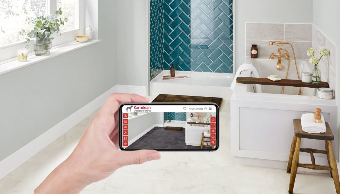a hand holding a phone in front of a bathroom 